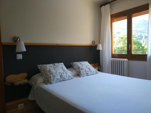 Postel nebo postele na pokoji v ubytování Hostal Vall d'Àssua