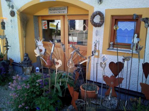 a front door of a house with flowers and plants at Haus der Sinne in Obernberg am Inn