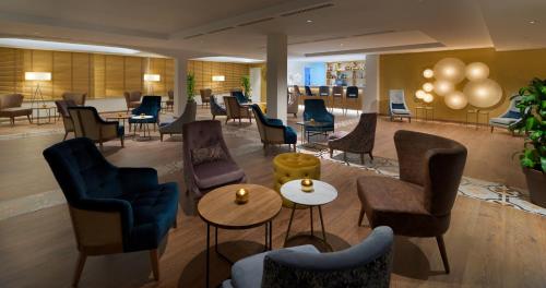 a lobby with chairs and tables in a hotel at H10 Ocean Dunas - Adults Only in Corralejo