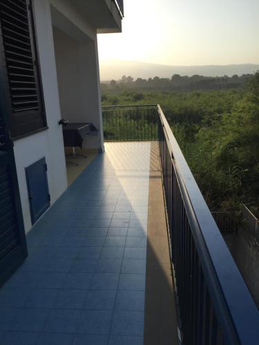 a balcony of a house with a view of a field at Valentina Holiday House in Mascali
