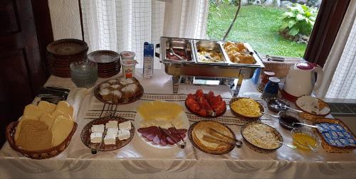 a table topped with lots of different types of food at Trenchova Guest House in Bansko