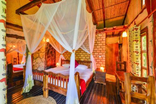 A bed or beds in a room at Serenada Eco Resort