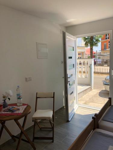 a room with a table and a chair and a door at Apartment Patrizia in Zadar