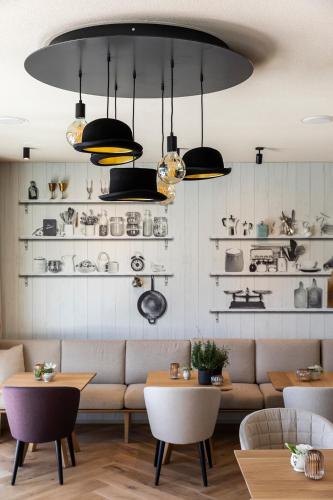 a living room with a couch and shelves of ceramics at Gloriette Guesthouse Boutiquehotel in Soprabolzano