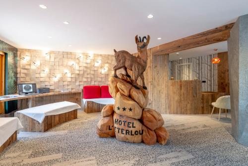 a room with a large stuffed animal in the middle at Hotel Eterlou in Méribel