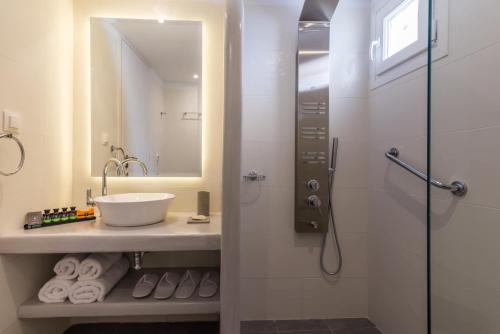 a bathroom with a sink and a shower at Babounis Suite in Péran Triovasálos