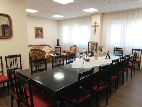 a large dining room with a long table and chairs at Casa Ospitalità San Giuseppe in LʼAquila