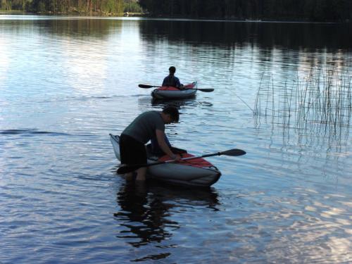 two people are in kayaks on a lake at Bjursås Berg & Sjö in Bjursås