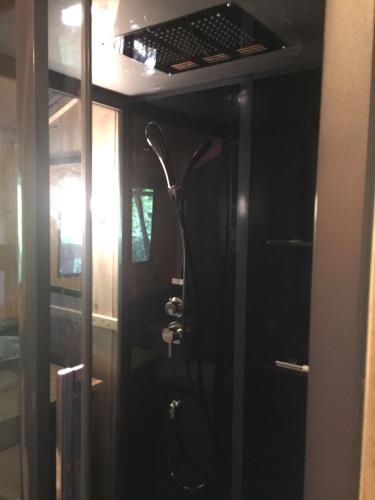 a bathroom with a shower in a room at Glamping Amsterdam "only to be reached by boat" in Baambrugse Zuwe