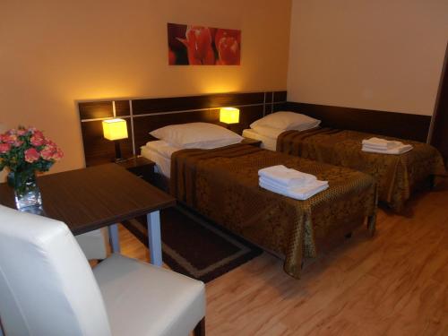 pokój hotelowy z dwoma łóżkami i stołem w obiekcie Villa Ramzes w Gdańsku