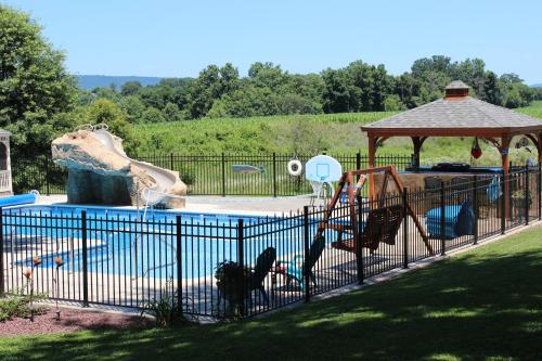 a pool with a water slide in a park at Carriage Stop Bed & Breakfast in Palmyra