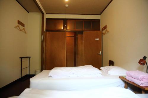 Voodi või voodid majutusasutuse Yuzan Guesthouse toas