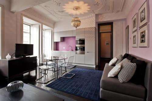 a living room with a couch and a table at Apartments of the Marques in Lisbon