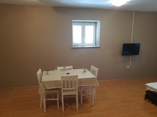 a table and chairs in a room with a window at Apartment Central in Šibenik