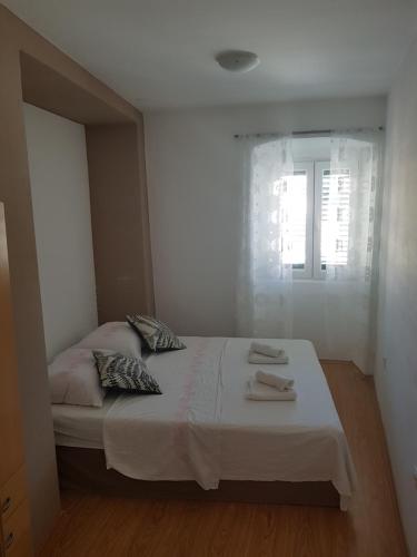 a bedroom with a bed with two towels on it at Apartment Central in Šibenik