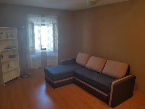 a living room with a couch and a window at Apartment Central in Šibenik