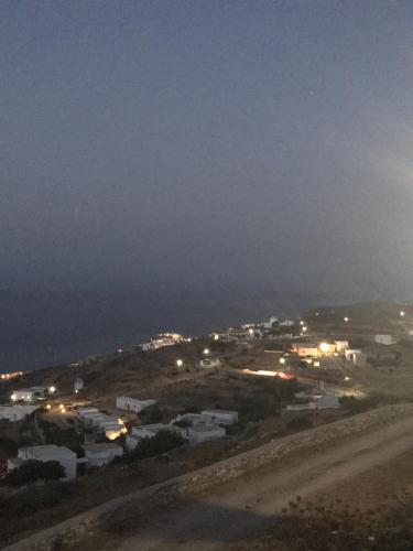 a view of a town at night with lights at Windmill Villas in Artemonas