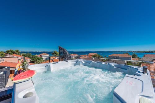 a hot tub with a watermelon on top of it at Luxury Apartments VilaMaloca in Vir