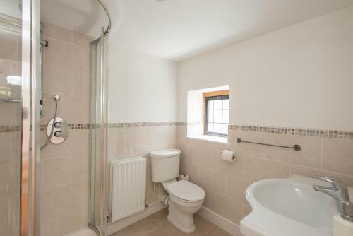 a bathroom with a toilet and a sink at 83 Downs Hill in Beckenham