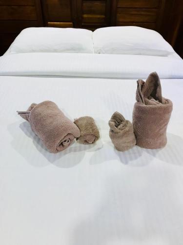 Ένα ή περισσότερα κρεβάτια σε δωμάτιο στο We Care Resort