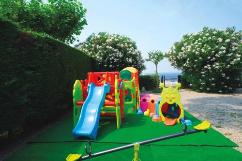 a childrens playground with a colorful play equipment at Hotel Du Lac et Bellevue in Bardolino
