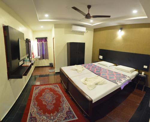 a bedroom with a bed with towels on it at Siva Guest House in Mahabalipuram