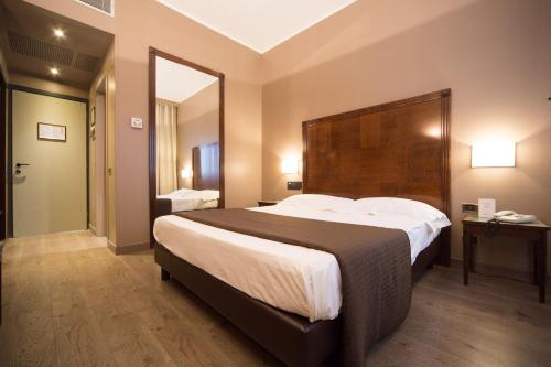 Säng eller sängar i ett rum på Hotel Motel Ascot