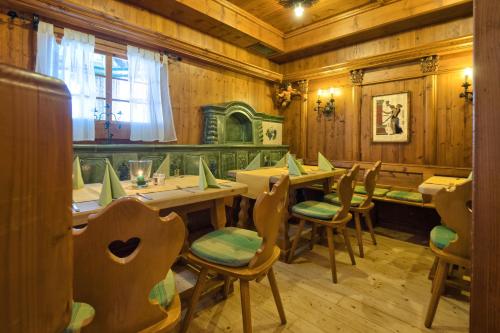 a restaurant with wooden walls and wooden tables and chairs at Hotel Mythos in Rust