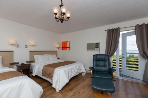Ένα ή περισσότερα κρεβάτια σε δωμάτιο στο Motel au Fleuve d'Argent