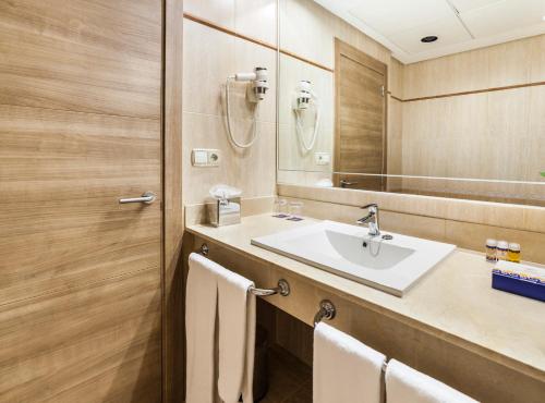 a bathroom with a sink and a mirror at Globales Santa Lucia - Adults Only 18 in Palmanova