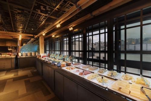 a buffet line with plates of food in a restaurant at Novotel Istanbul Bosphorus Hotel in Istanbul