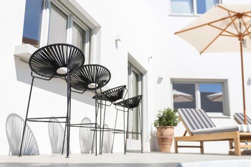 a group of chairs sitting on a patio at Aegean Gem in Kamari