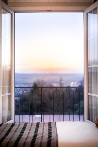 a bedroom with a large window with a view at Best Western Hotel Ile de France in Château-Thierry