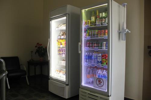 an open refrigerator filled with lots of drinks at Hotel Village Campinas in Campinas