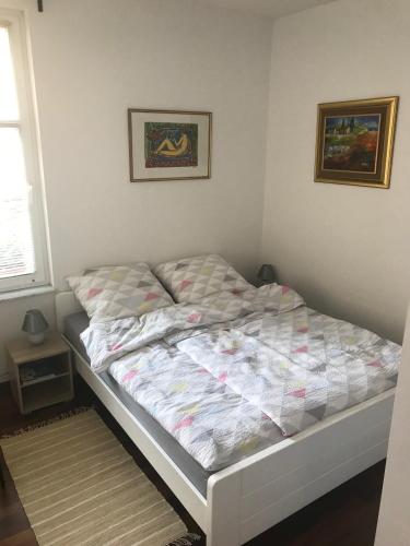 a bedroom with a bed with a quilt on it at Apartment A-zone Zagreb in Zagreb