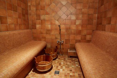 two benches in a room with two trash cans at Hotel Am Eifelsteig in Neroth
