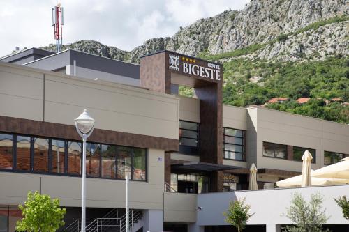 a building with a mountain in the background at Hotel Bigeste in Ljubuški