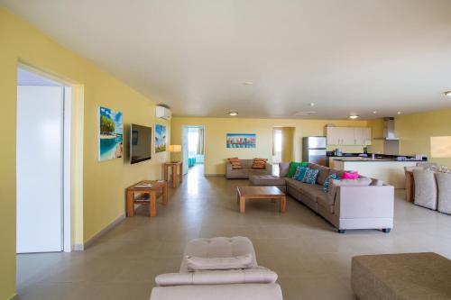 a large living room with a couch and a kitchen at Blue Bay Apartments in Sint Michiel