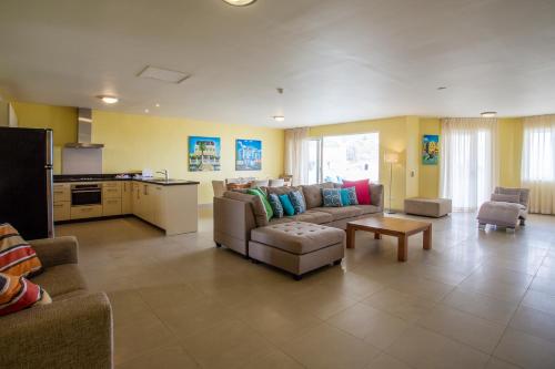 a large living room with a couch and a table at Blue Bay Apartments in Sint Michiel