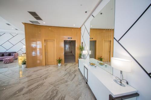 an office lobby with a reception desk and a mirror at Sole Luna Hotel in Borsh