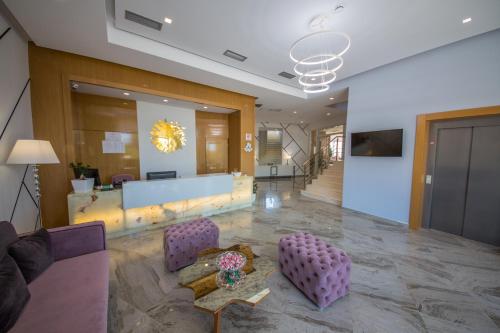 a lobby with purple chairs and a table in a building at Sole Luna Hotel in Borsh