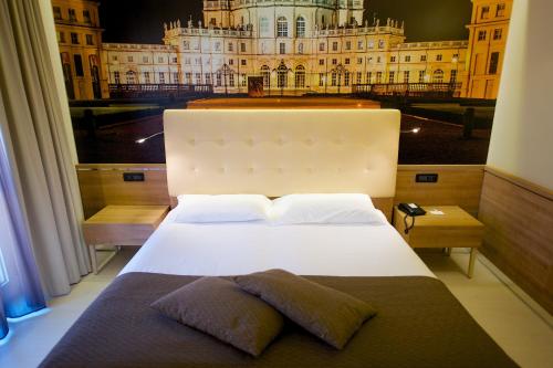 a bedroom with a large bed with a view of a building at Best Western Hotel Luxor in Turin