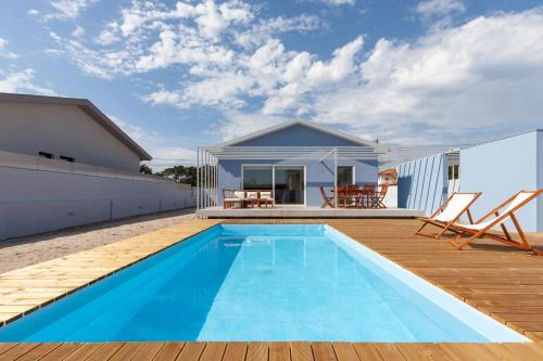 a swimming pool on the deck of a house at Blue Dreams in Ovar