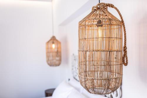 a bird cage hanging from a wall at Aegean Gem in Kamari