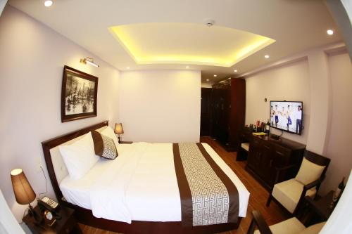 a bedroom with a bed and a television in it at Le Bordeaux Sapa Hotel in Sa Pa