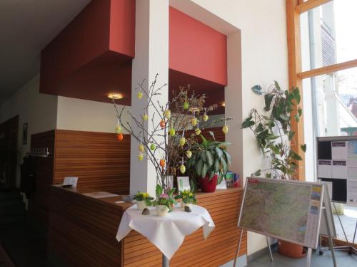 a room with a table with flowers on it at Wohlfühlhotel Goiserer Mühle in Bad Goisern