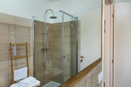 a shower with a glass door in a bathroom at FELICITA B&B in Acquaviva Picena