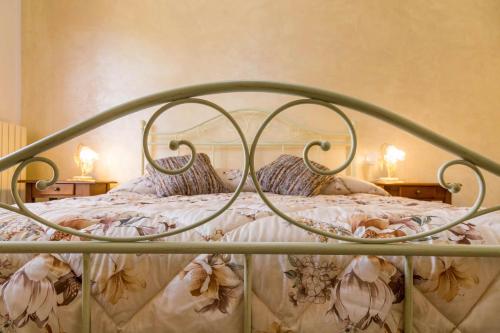 a bedroom with a bed with a metal frame at FELICITA B&B in Acquaviva Picena
