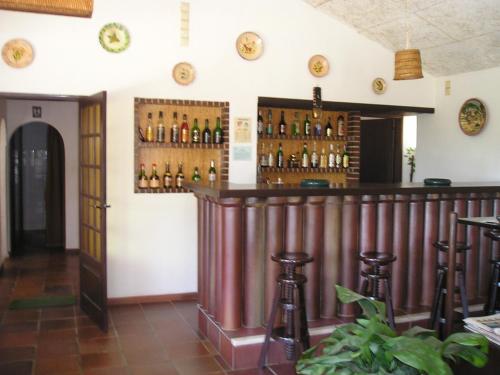 a bar in a restaurant with bottles on the wall at Apartamentos Turisticos Marsol in Lagos