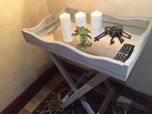 a table with candles and a remote control on it at Spacube Luxury Suites and Spa in Pretoria
